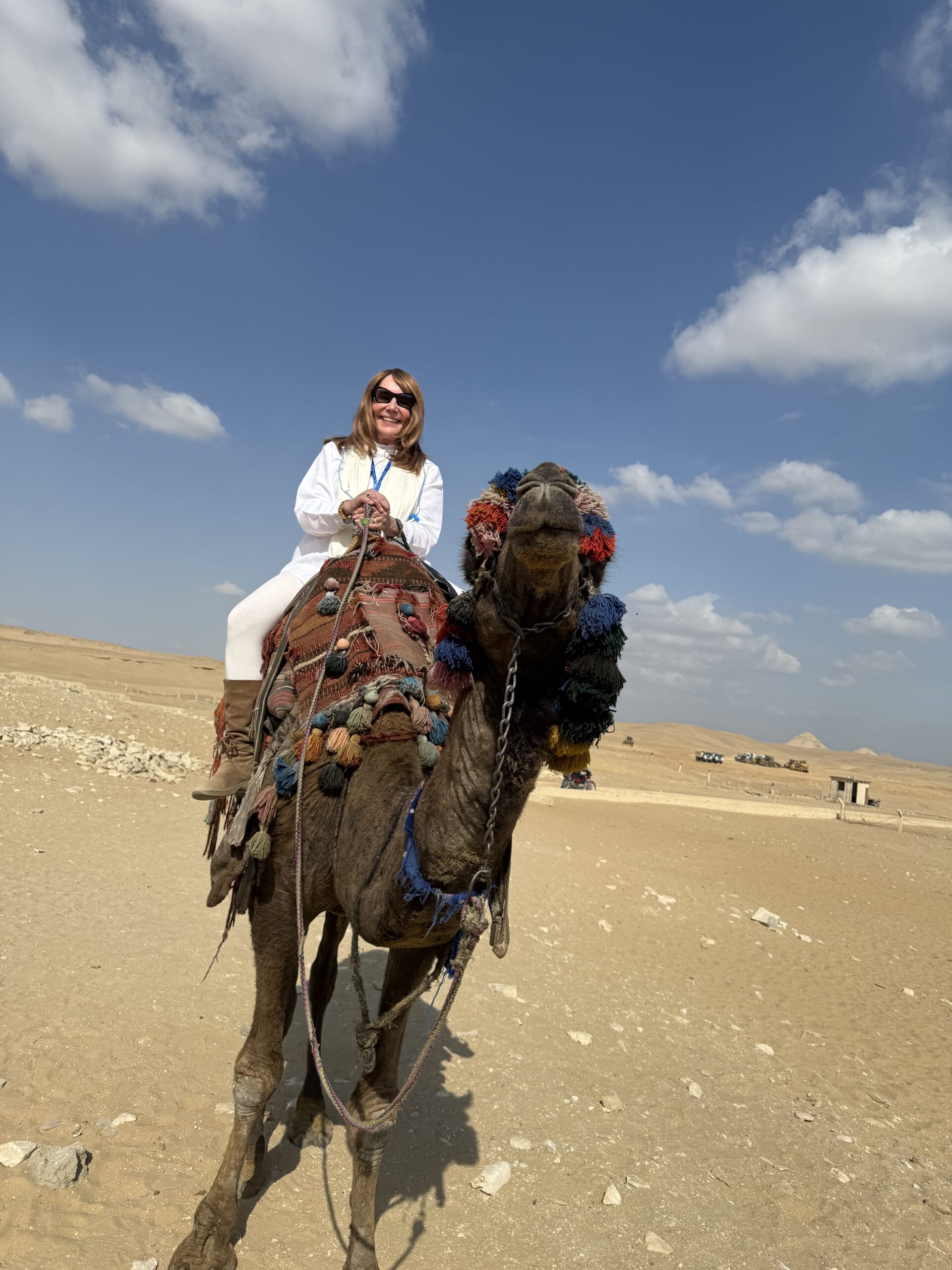 Debra Stangl riding a camel in Egypt.