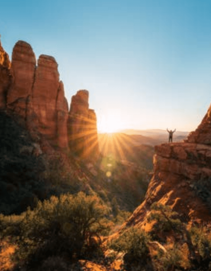 Arms open on a cliff in Sedona