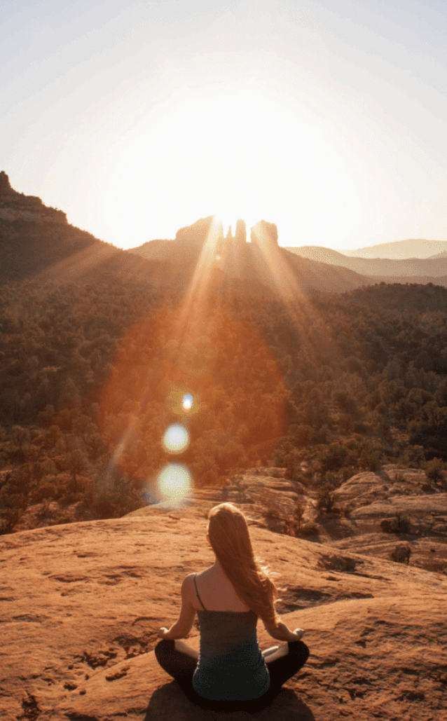A woman meditating in the Sedona vortex energy.